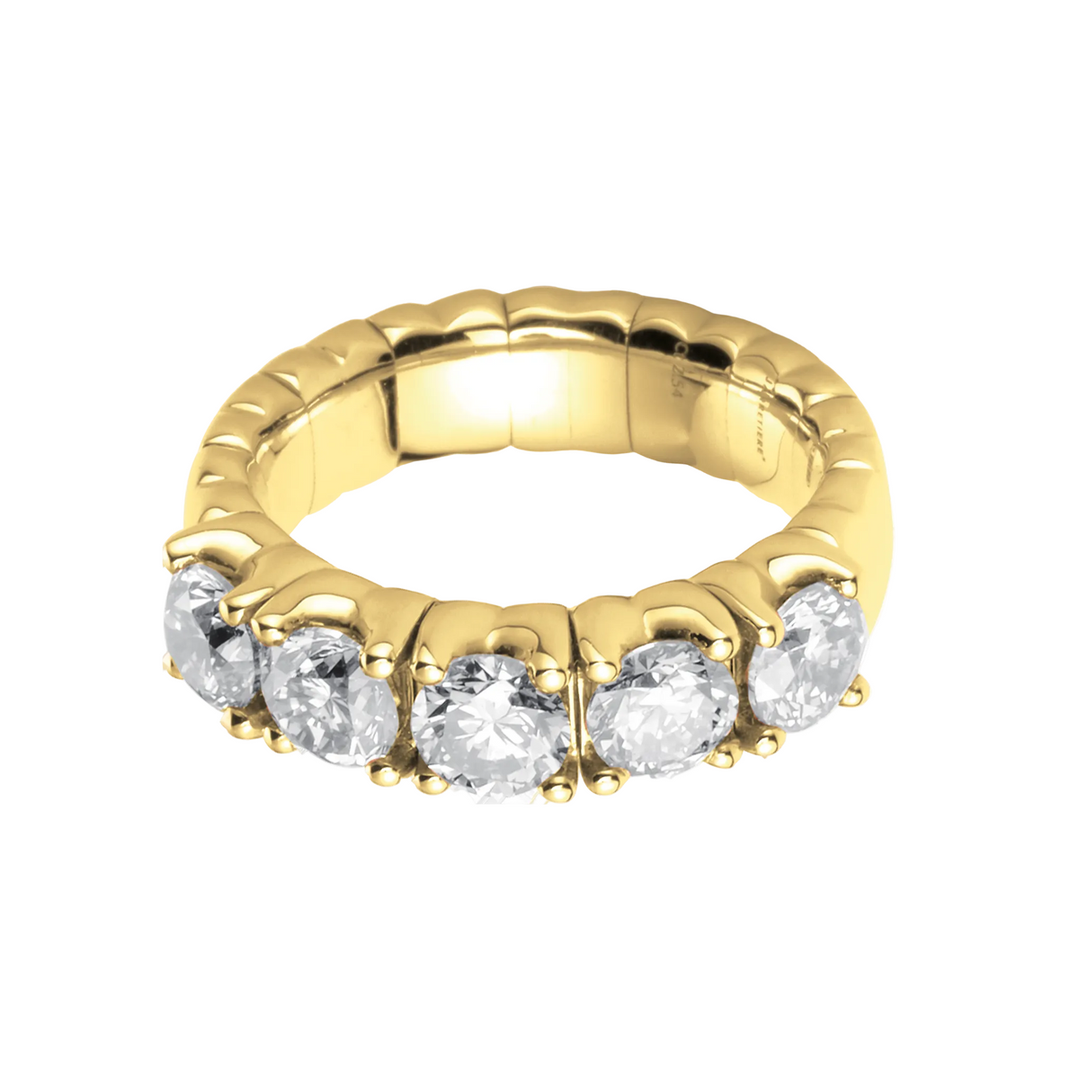 Gold ring with clear gemstones on a white background