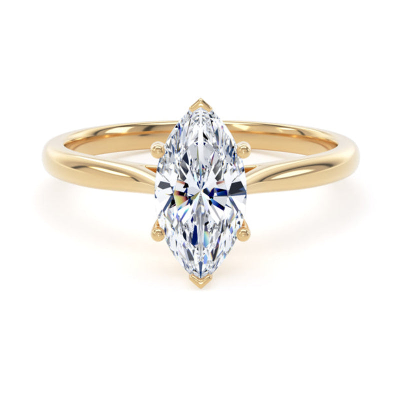 A yellow gold ring featuring a marquise-cut clear gemstone in a four-prong setting, shown against a plain white background.