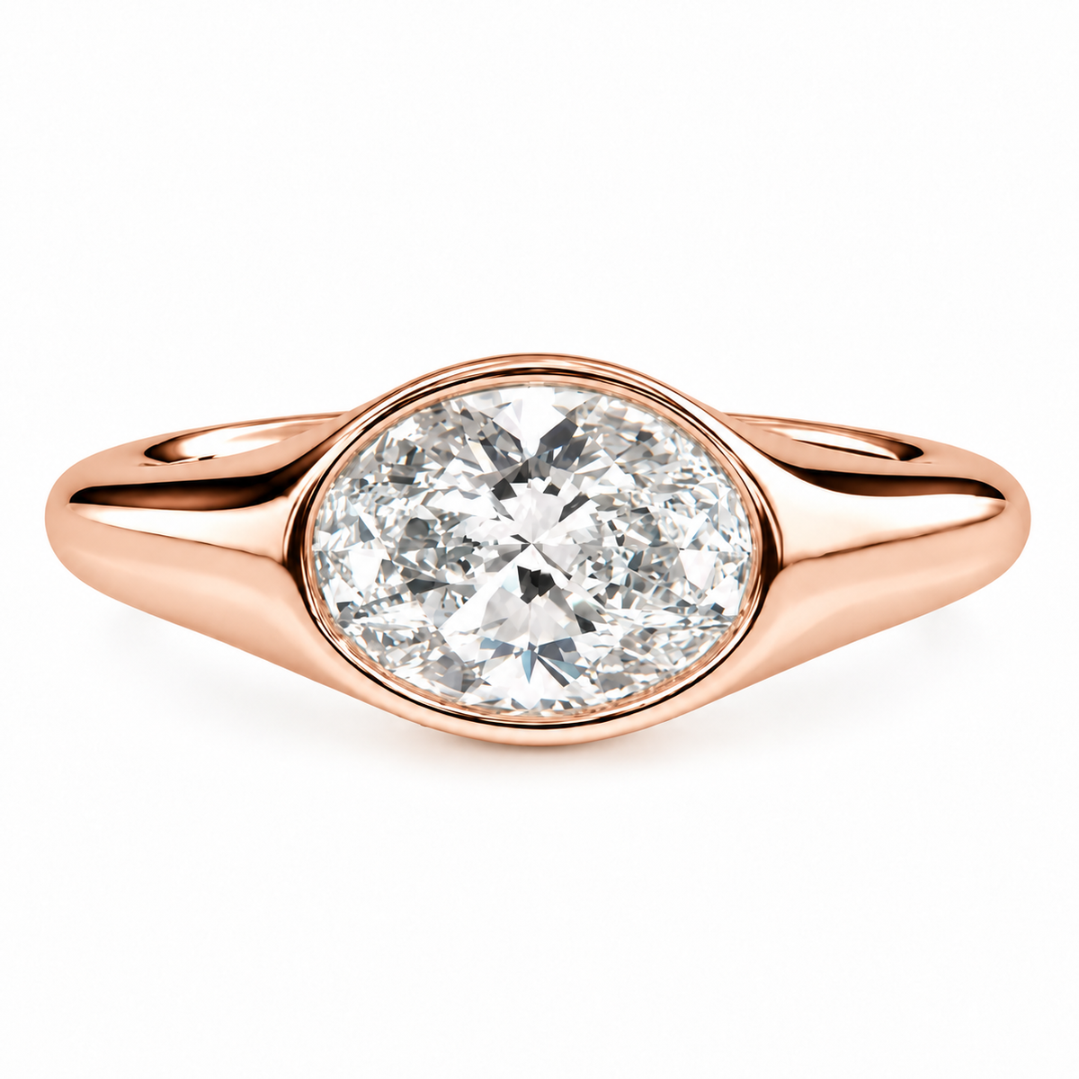 A rose gold oval solitaire ring featuring a brilliant oval-cut diamond in a bezel setting, shown on a clean white background.