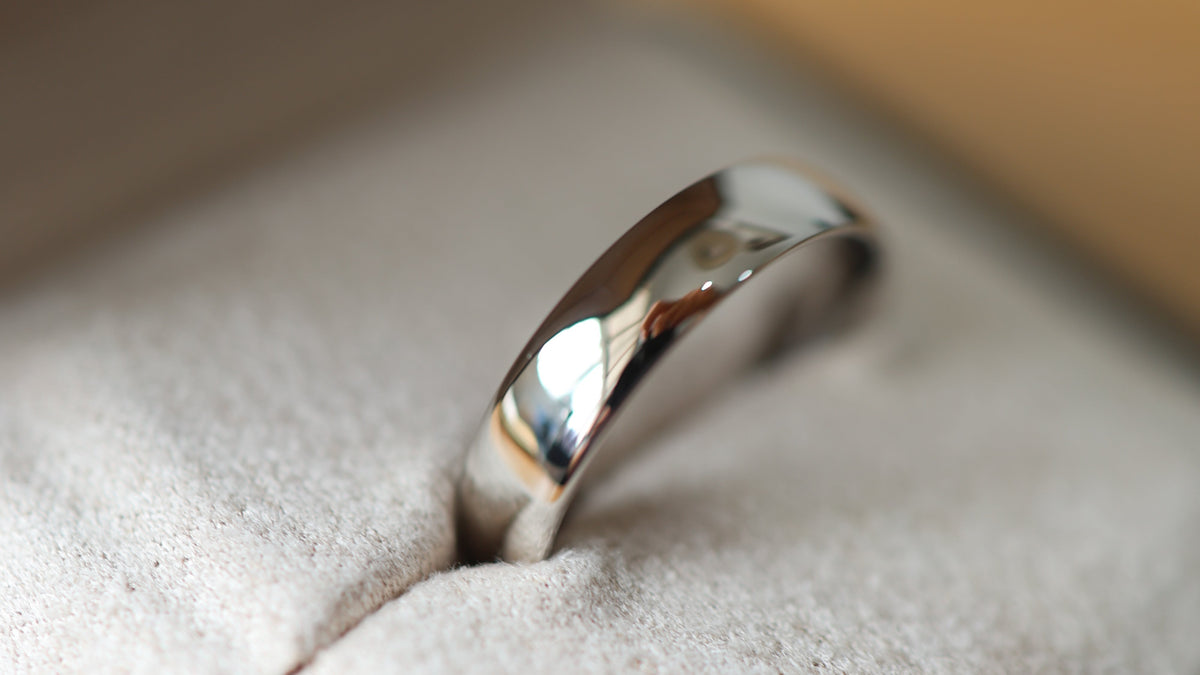 a classic wedding band in platinum in a black ring box