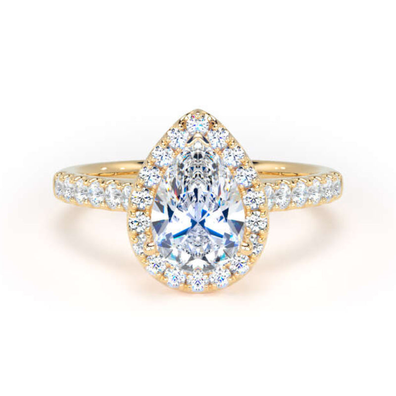A pear-cut halo ring featuring a central clear gemstone surrounded by a halo and pavé-set side stones on a yellow gold band, shot against a plain white background.
