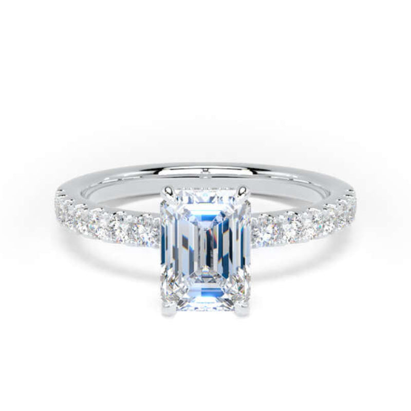 An emerald-cut diamond engagement ring with a silver-colored band set with small round diamonds, centered on a plain white background.