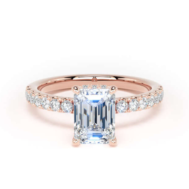An emerald-cut diamond engagement ring in rose gold with a diamond pavé band, set against a plain white background.