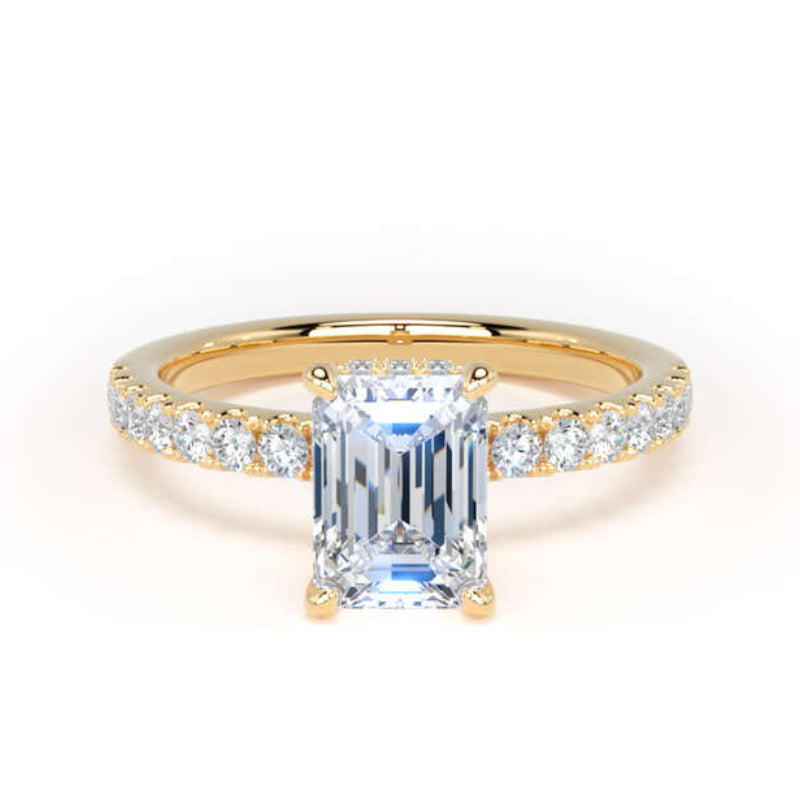 A yellow gold ring featuring a large emerald-cut clear center stone and a pavé-set diamond band, shown on a clean white background.