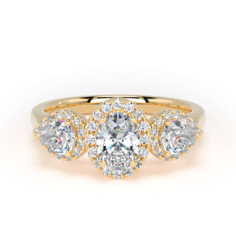 A yellow gold three-stone ring featuring a central oval-cut diamond surrounded by a halo of small diamonds, flanked by two marquise-cut diamonds in similar halo settings, on a clean white background.