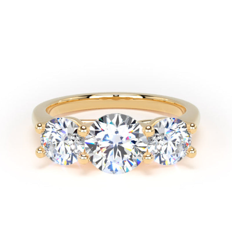 A yellow gold three-stone ring featuring a round center diamond flanked by two round side diamonds, set against a plain white background.