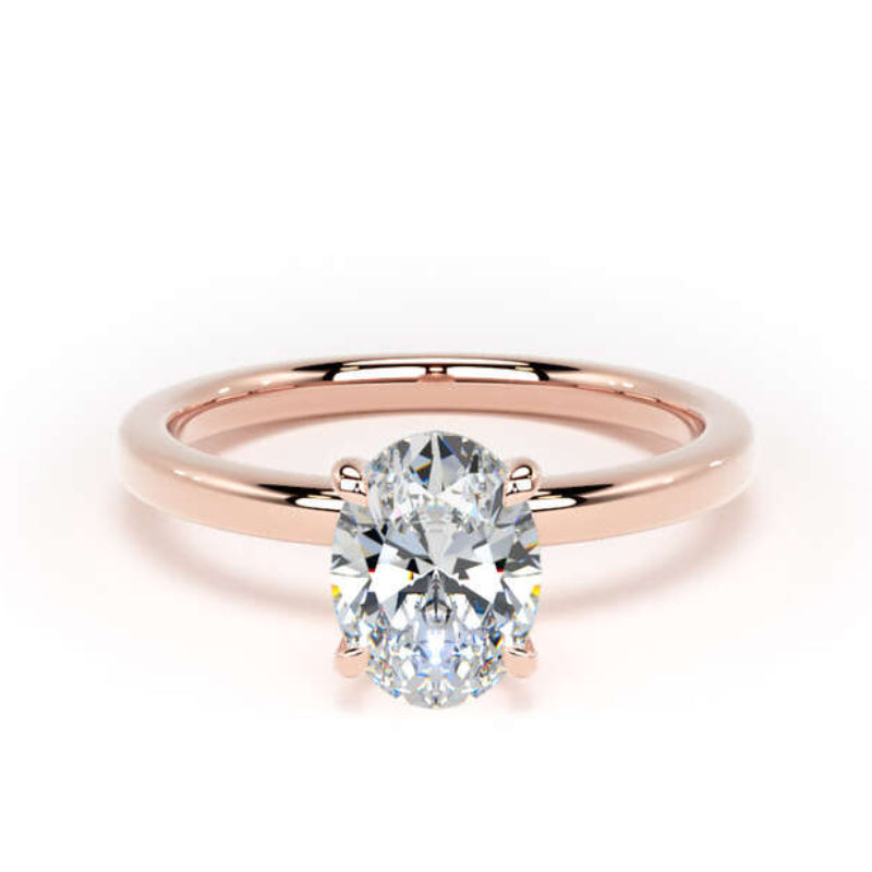 An oval-cut diamond engagement ring with a polished rose gold band, centered on a clean white background.