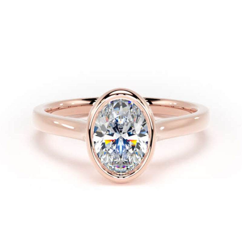 A rose gold ring featuring an oval-cut clear gemstone in a bezel setting, shown against a plain white background.