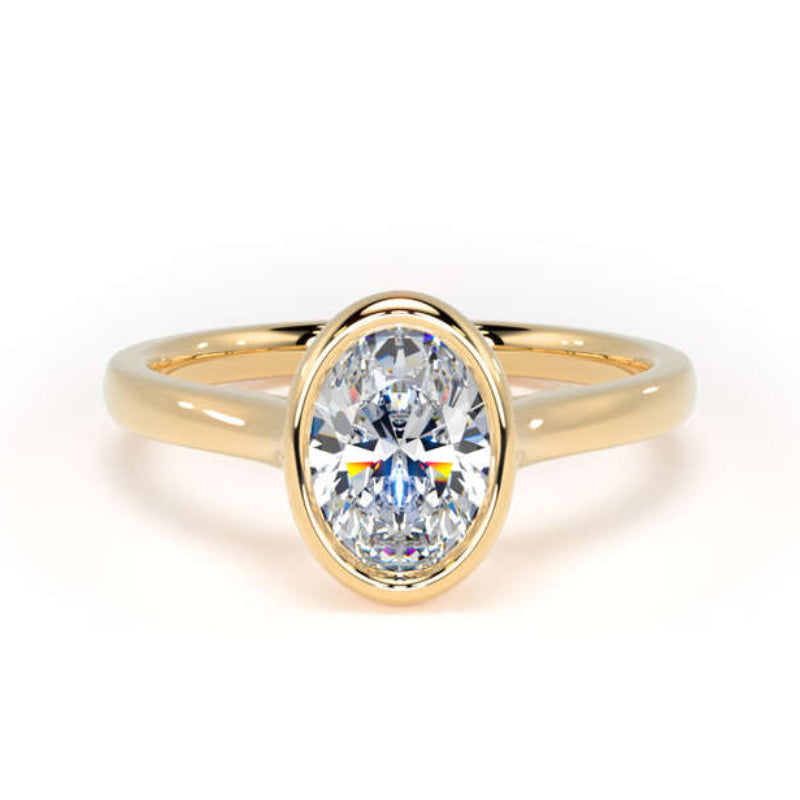 A yellow gold ring featuring a marquise-cut clear gemstone in an oval bezel setting, shown against a plain white background.