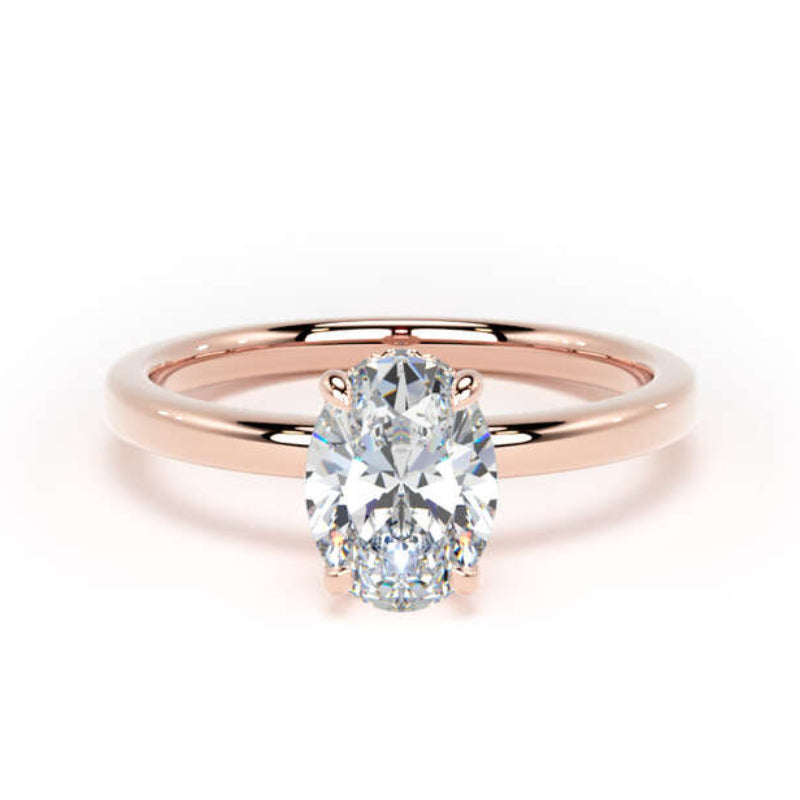 An oval-cut diamond engagement ring with a polished rose gold band, centered on a clean white background.