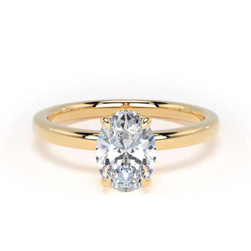 A yellow gold solitaire engagement ring featuring a brilliant round-cut diamond in a four-prong setting, shown on a clean white background.