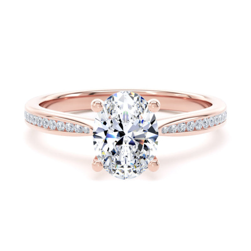 A rose gold engagement ring featuring a round brilliant-cut center stone in a four-prong setting, with a pavé band accented by small round diamonds, shown on a clean white background.