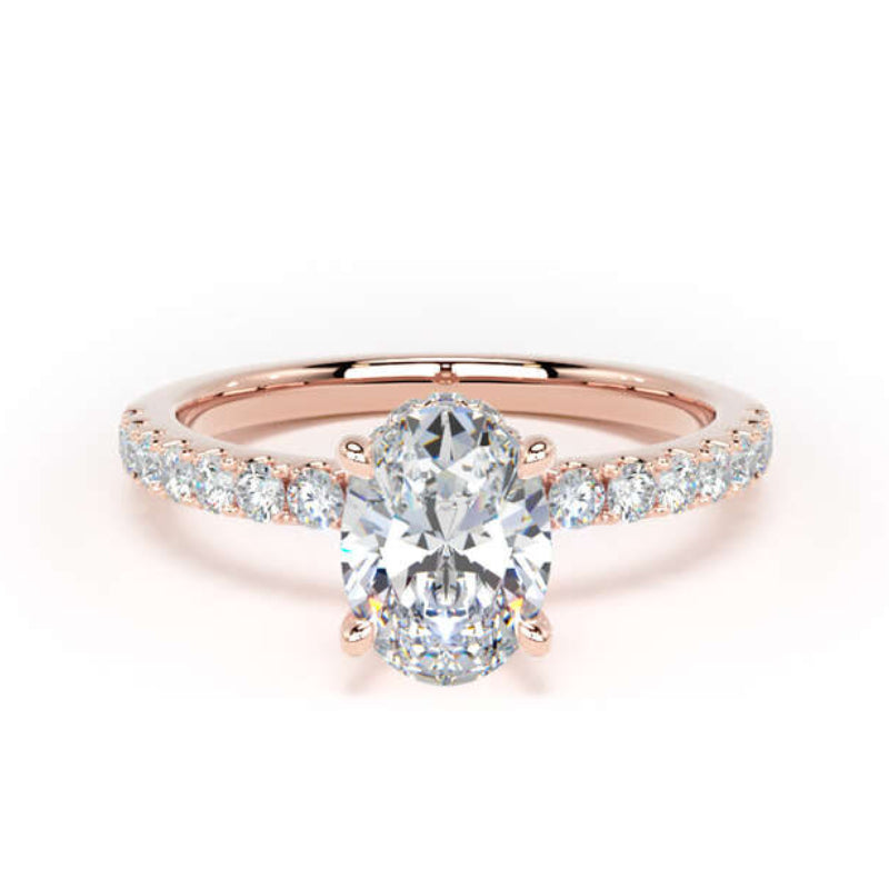 A rose gold engagement ring featuring a pear-cut center diamond and a pavé band with small round diamonds, set against a plain white background.