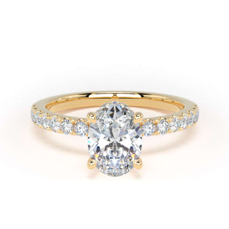 A yellow gold engagement ring featuring a large oval-cut center stone and a pavé-set diamond band, shown on a clean white background.