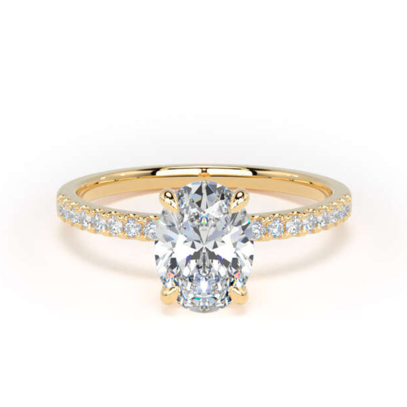 A yellow gold solitaire engagement ring featuring a large oval-cut center stone and a pavé-set diamond band, shown on a clean white background.