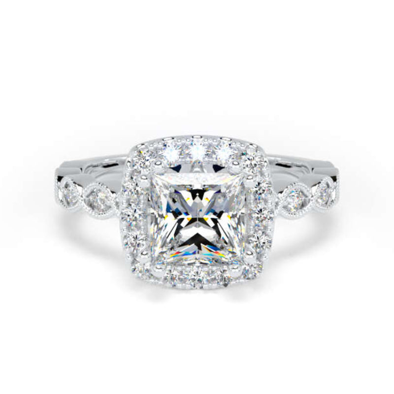 A radiant cut diamond halo ring in silver-colored metal, featuring a central radiant diamond surrounded by a halo and smaller side diamonds on a clean white background.
