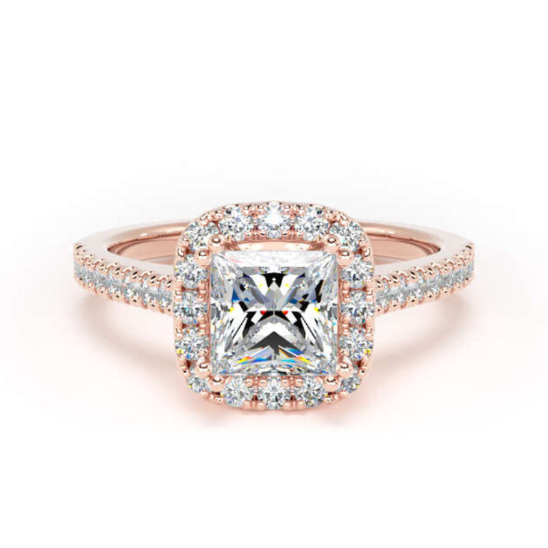 A rose gold halo ring featuring a large cushion-cut center diamond surrounded by a halo of smaller diamonds, with a pavé diamond band, shown on a white background.