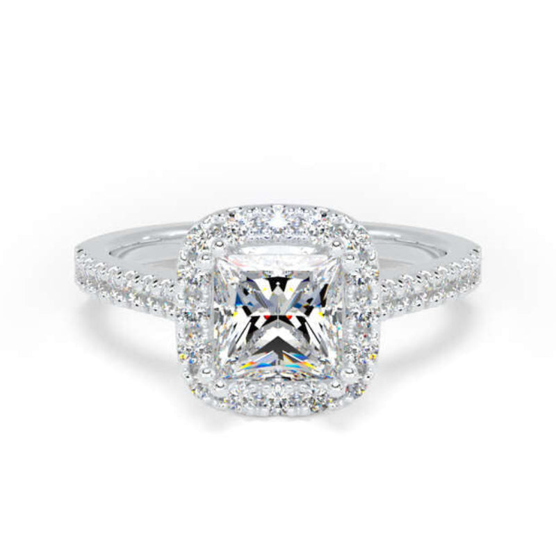 A radiant cut halo ring in silver-toned metal with a cushion-shaped center stone and small surrounding stones on the band, shown on a plain white background.