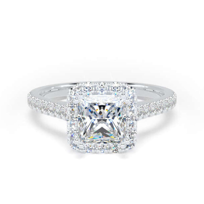 An radiant cut diamond halo ring in a silver-colored metal, featuring a large central diamond surrounded by a halo and a pavé-set band, shown on a plain white background.