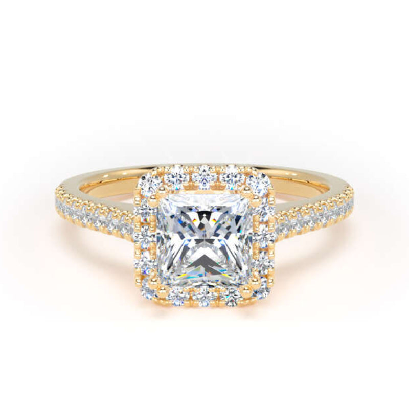A yellow gold halo ring featuring a large square radiant-cut center stone surrounded by a double halo of small round stones, with the band decorated with pavé-set stones, shown on a plain white background.