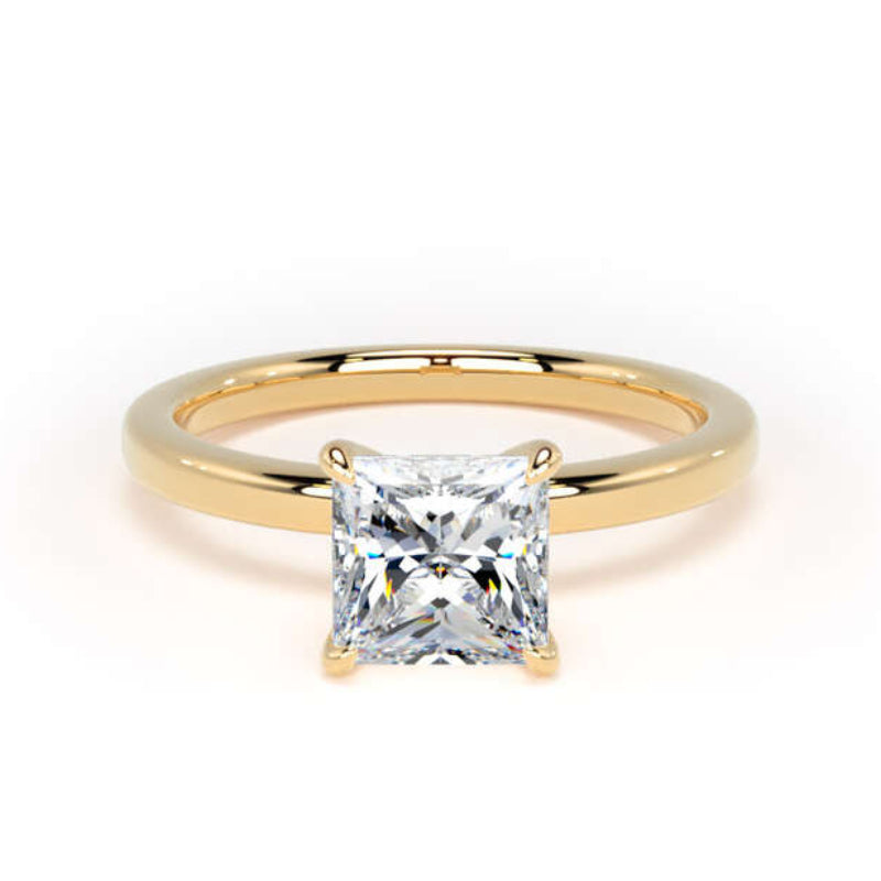 A classic princess-cut diamond engagement ring with a yellow gold band, shown on a clean white background.