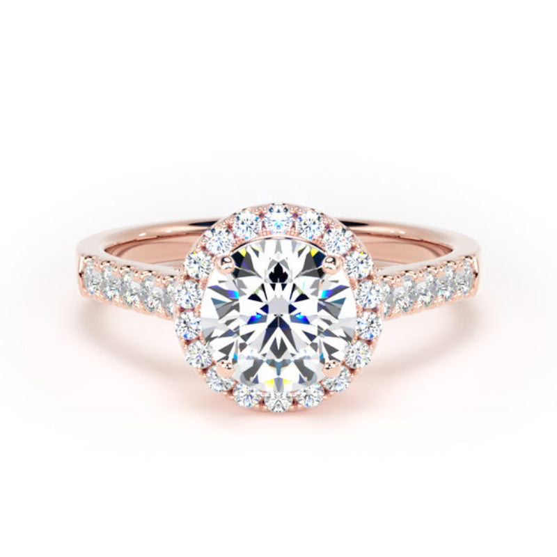 A rose gold halo engagement ring featuring a round brilliant-cut center diamond surrounded by a halo of smaller diamonds, with additional diamonds set along the shoulders of the band, shown on a clean white background.