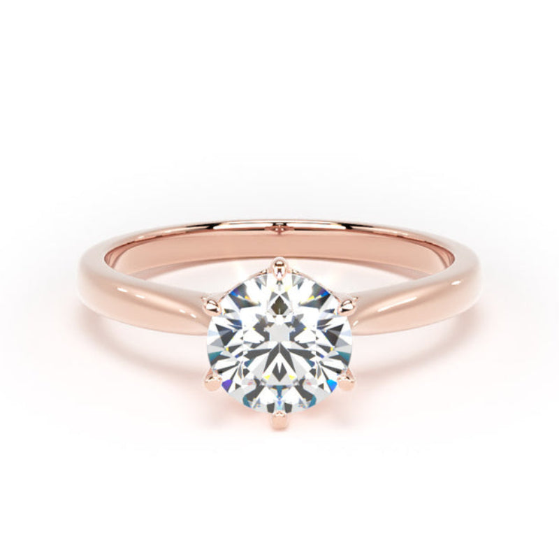 A rose gold solitaire engagement ring with a round brilliant-cut diamond center stone, set against a clean white background.