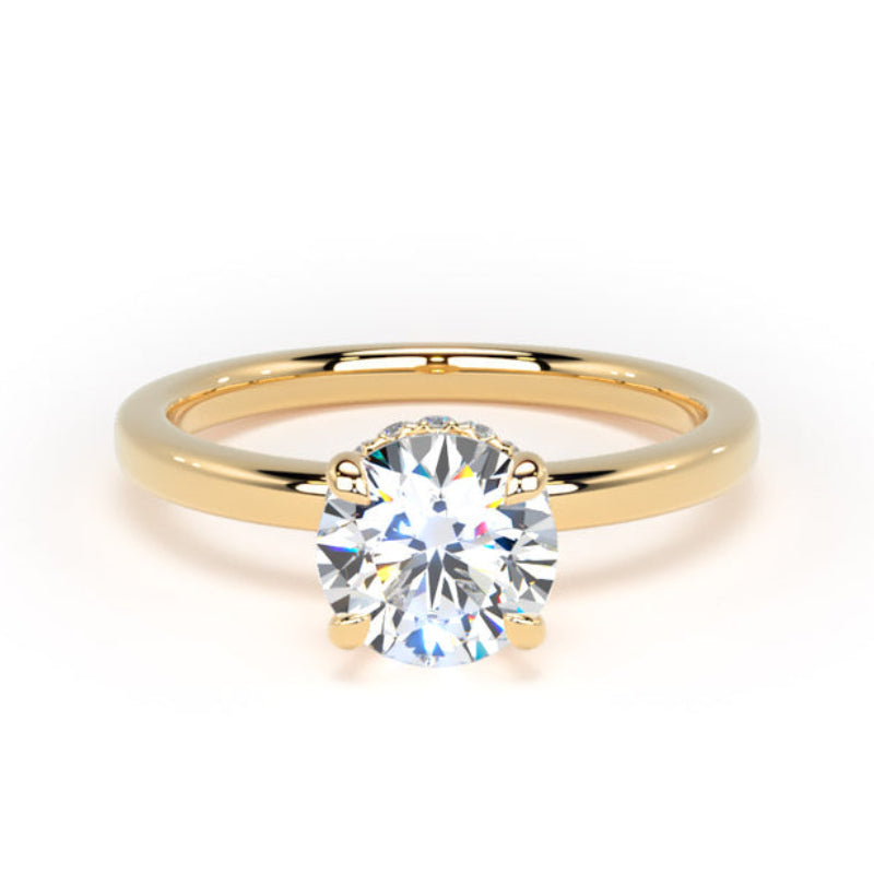 A classic solitaire engagement ring featuring a round brilliant-cut diamond set in a polished yellow gold band, shown on a clean white background.