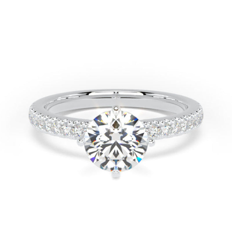 A silver engagement ring featuring a round-cut center diamond flanked by pavé diamonds on a white gold or platinum band, set against a plain white background.