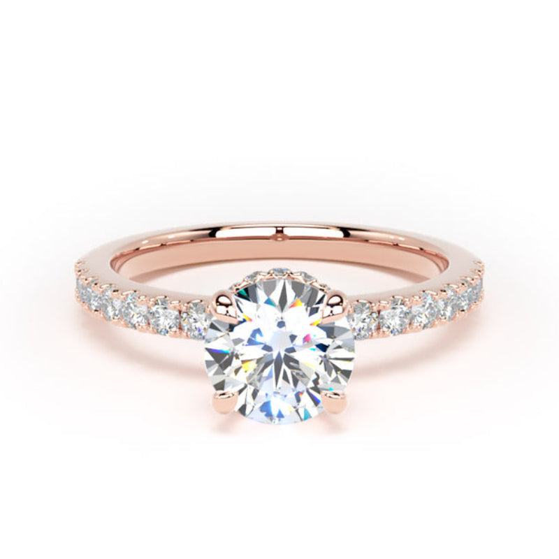 A rose gold engagement ring featuring a round brilliant-cut center stone and a pavé band with small round stones, set against a plain white background.