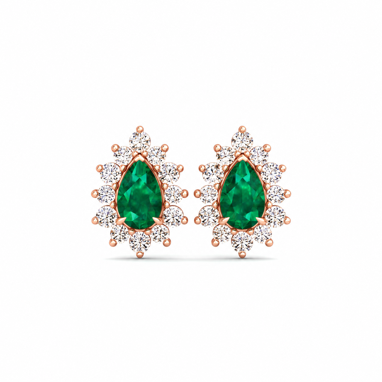 A pair of rose gold stud earrings featuring pear-cut green emeralds surrounded by small clear stones in a halo setting, shown on a plain white background.