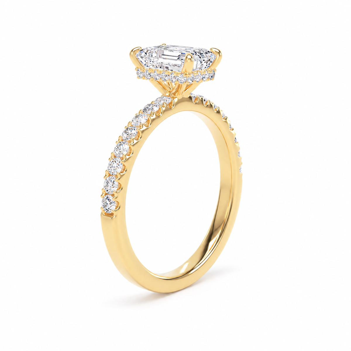 A yellow gold engagement ring featuring a large radiant-cut center stone and a halo of smaller stones, with a pavé-set shank, shown on a clean white background.