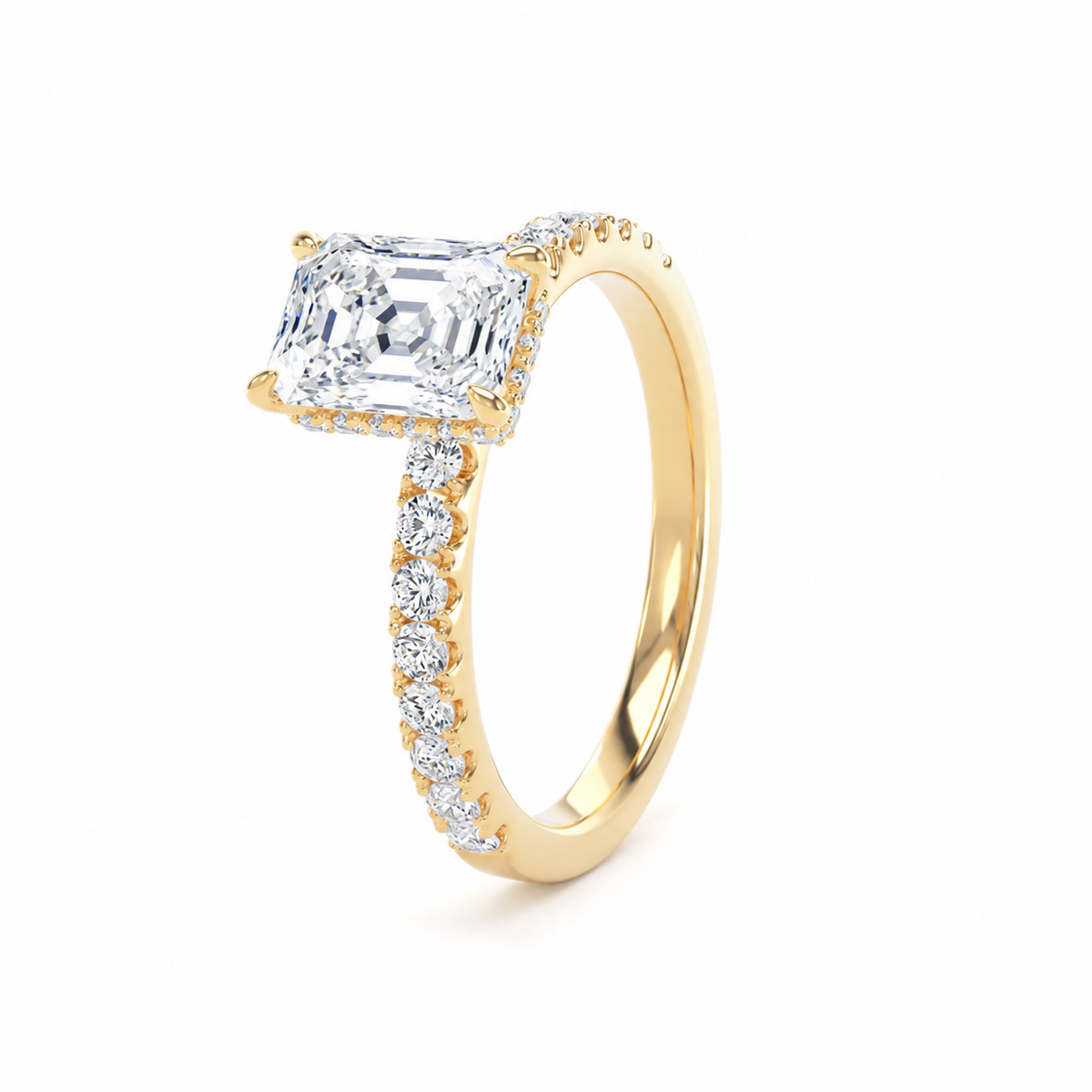 A yellow gold ring featuring a large rectangular radiant-cut clear gemstone in a four-prong setting, with a pavé band accented by small round diamonds, shown on a white background.