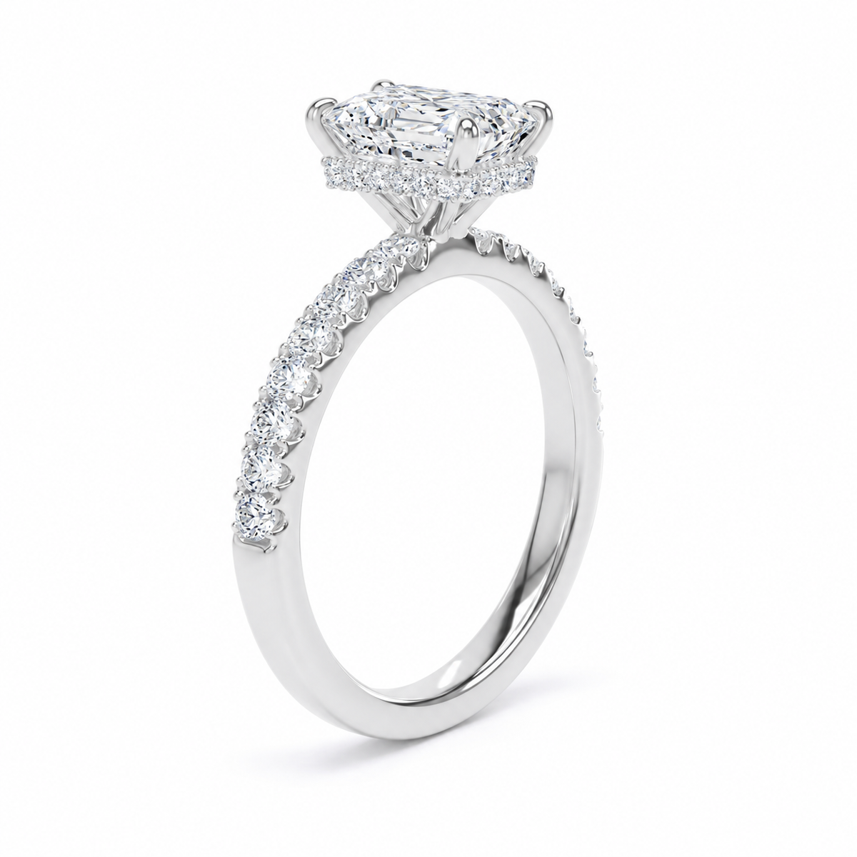 A radiant cut diamond engagement ring in a polished silver-colored metal, featuring a halo of small pavé-set diamonds along the band, shown on a clean white background.