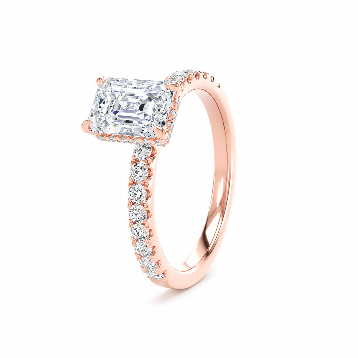 A rose gold engagement ring featuring a radiant-cut diamond center stone and a pavé-set diamond band, shown on a clean white background.