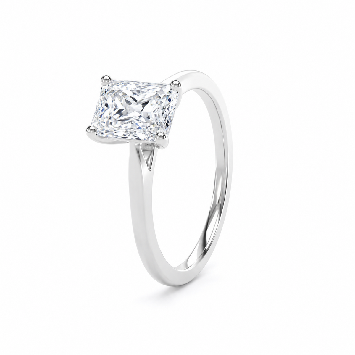 A radiant-cut diamond engagement ring in a four-prong setting on a polished white gold or platinum band, shown on a clean white background.