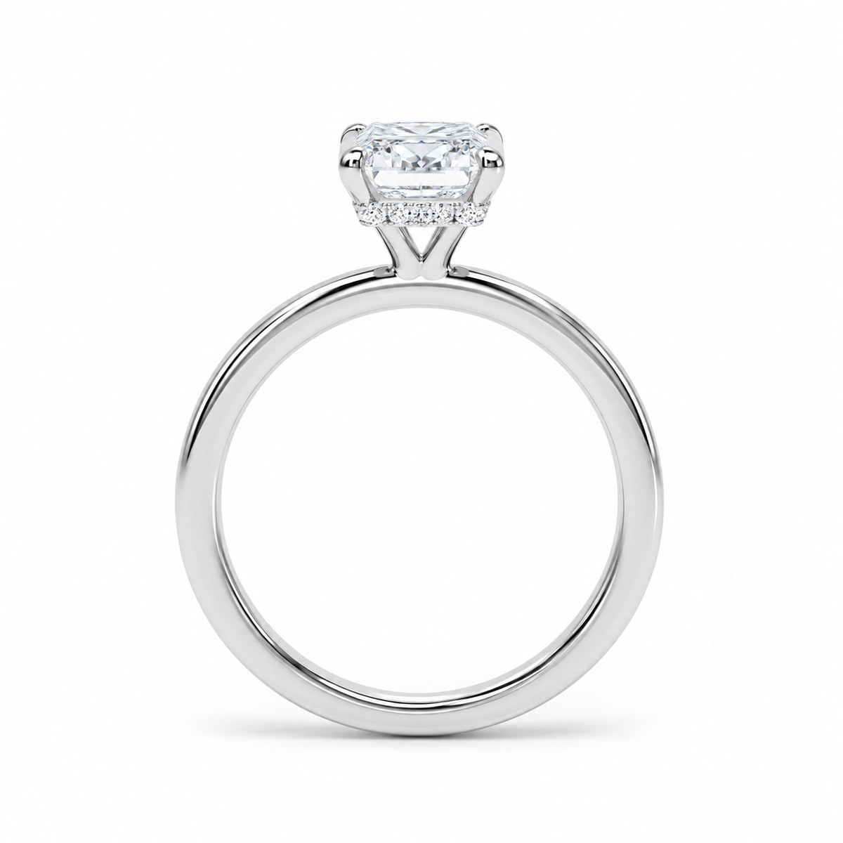 A silver-toned solitaire engagement ring with a radiant-cut diamond center stone and a small halo of pavé diamonds, shown on a clean white background.