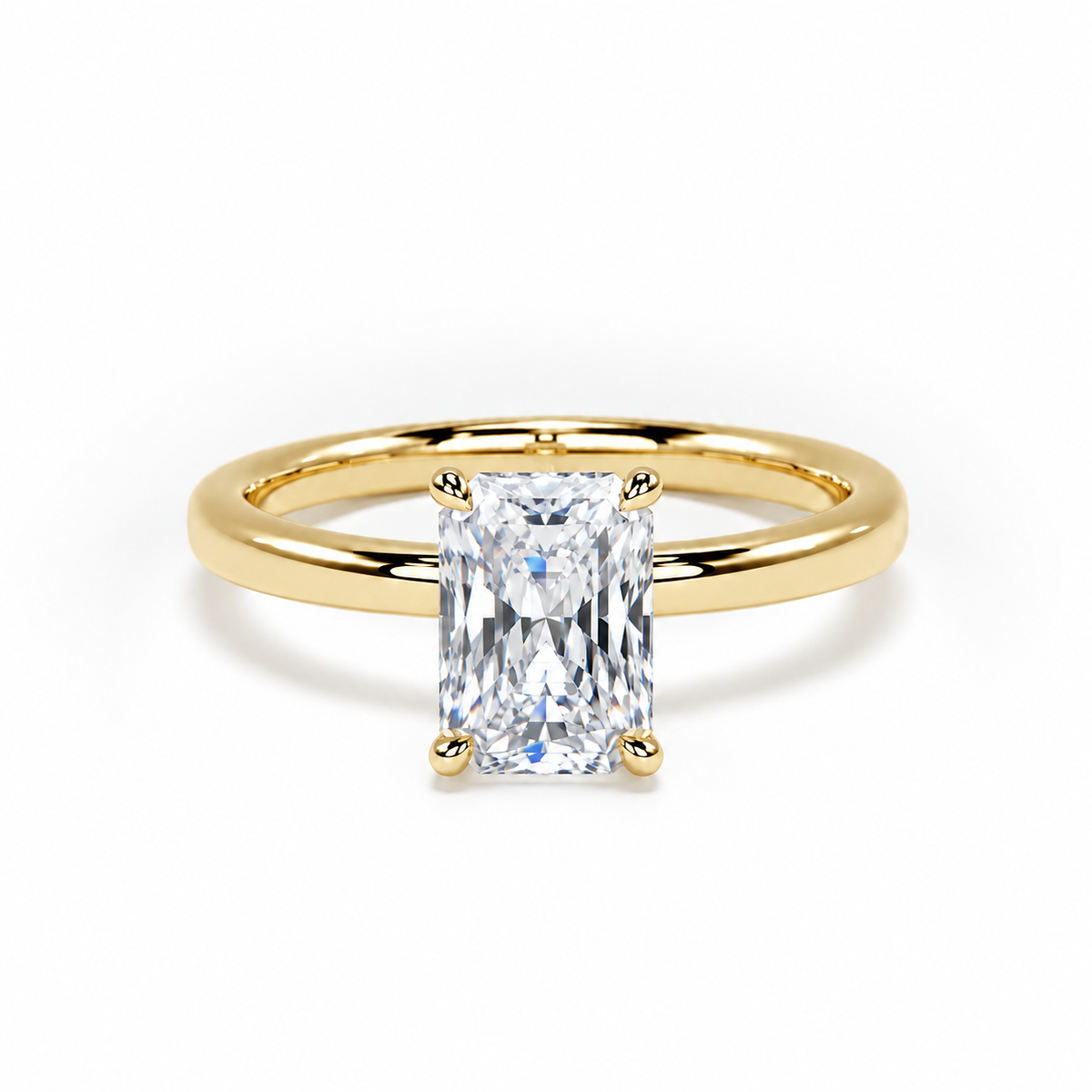 A yellow gold solitaire ring featuring a rectangular radiant-cut clear gemstone in a four-prong setting, shown on a clean white background.