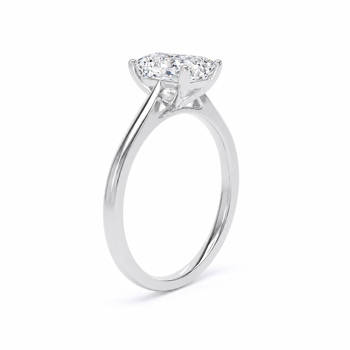 A silver-toned diamond ring with a radiant-cut center stone and a smaller round diamond beside it, shown on a clean white background.