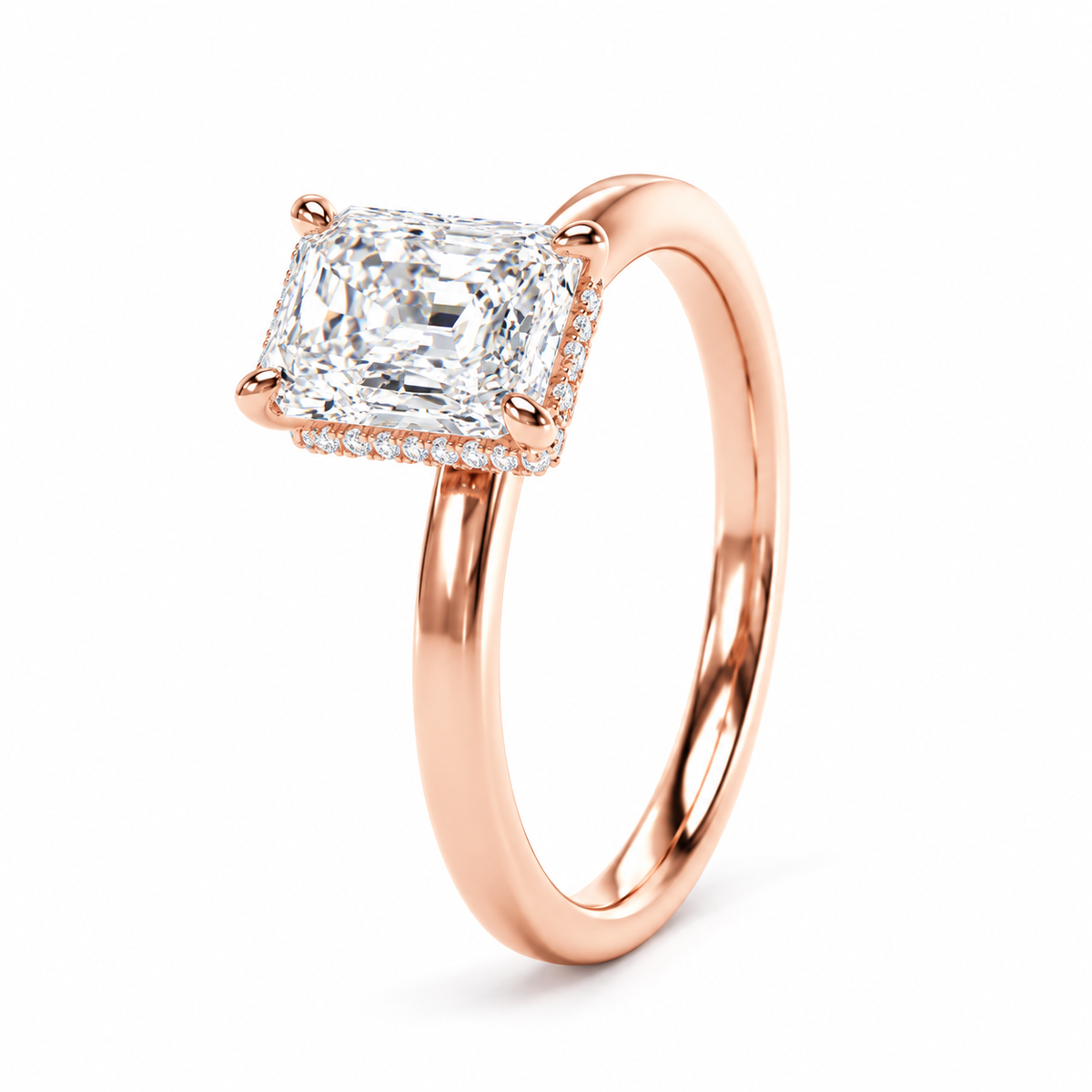 A rose gold engagement ring featuring a large elongated radiant-cut diamond center stone and a halo of small pavé diamonds, set on a polished band against a clean white background.