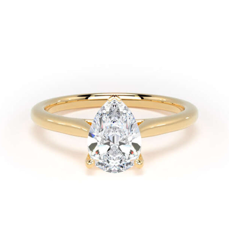 A pear-cut diamond engagement ring with a yellow gold band, shown on a clean white background.