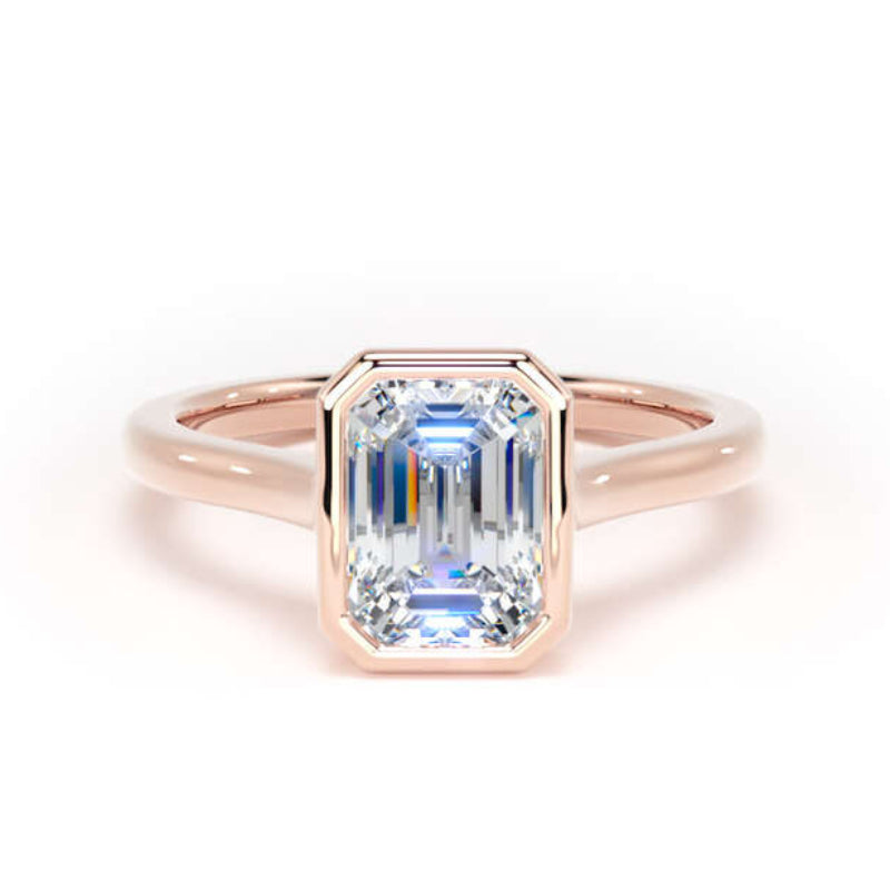An emerald-cut diamond ring set in a rose gold band, photographed on a clean white background.