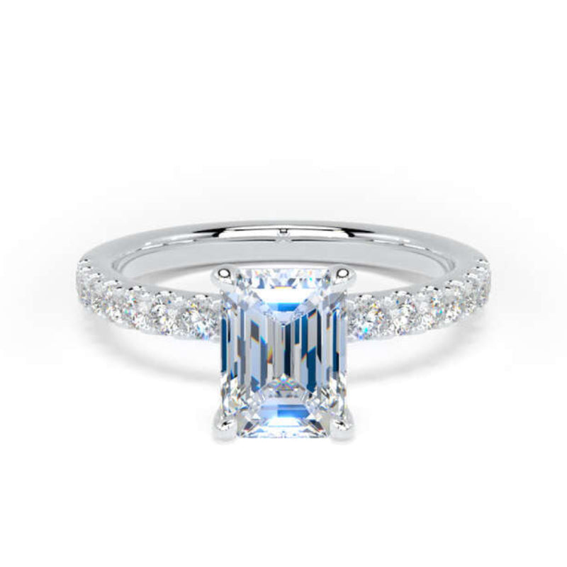 An emerald-cut diamond ring with a silver-colored band accented by small round diamonds, set against a plain white background.
