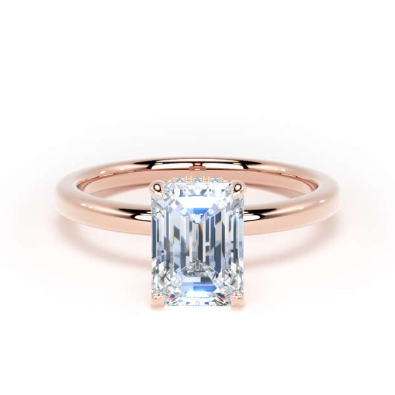An emerald-cut diamond ring set in a polished rose gold band, shown against a plain white background.