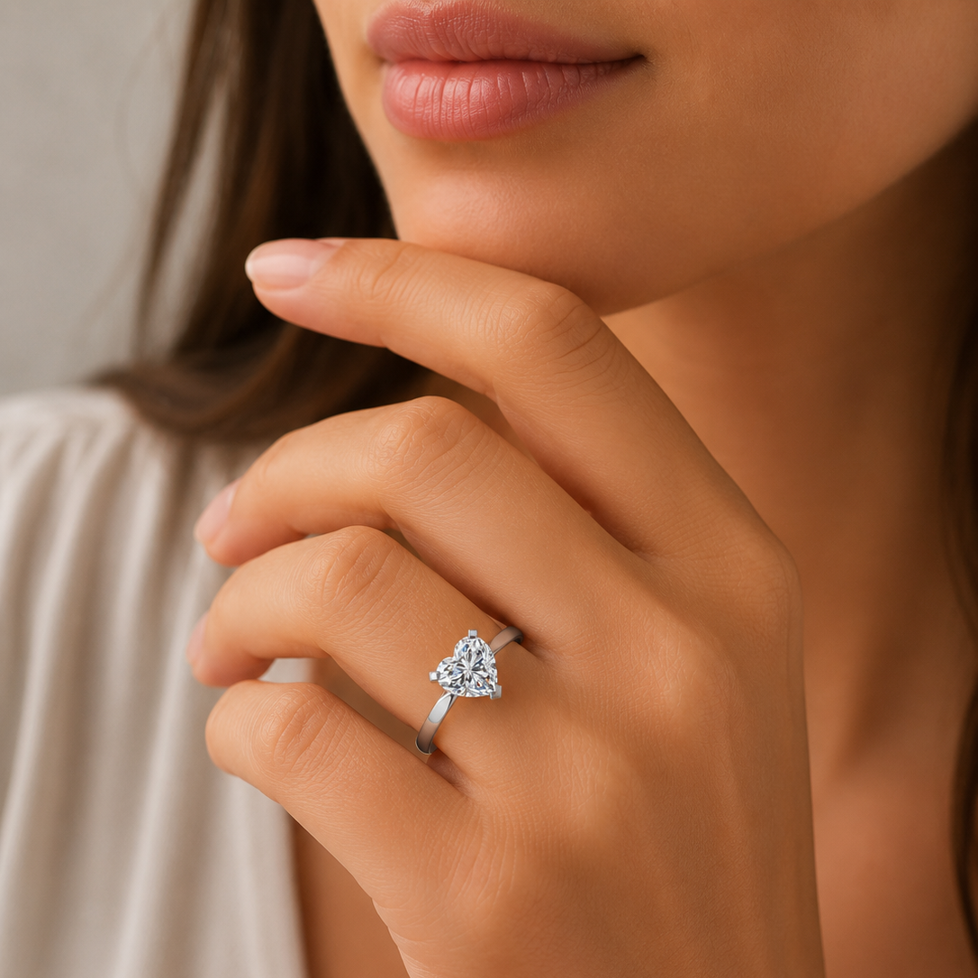 Close-up of a hand wearing a diamond ring with a neutral background