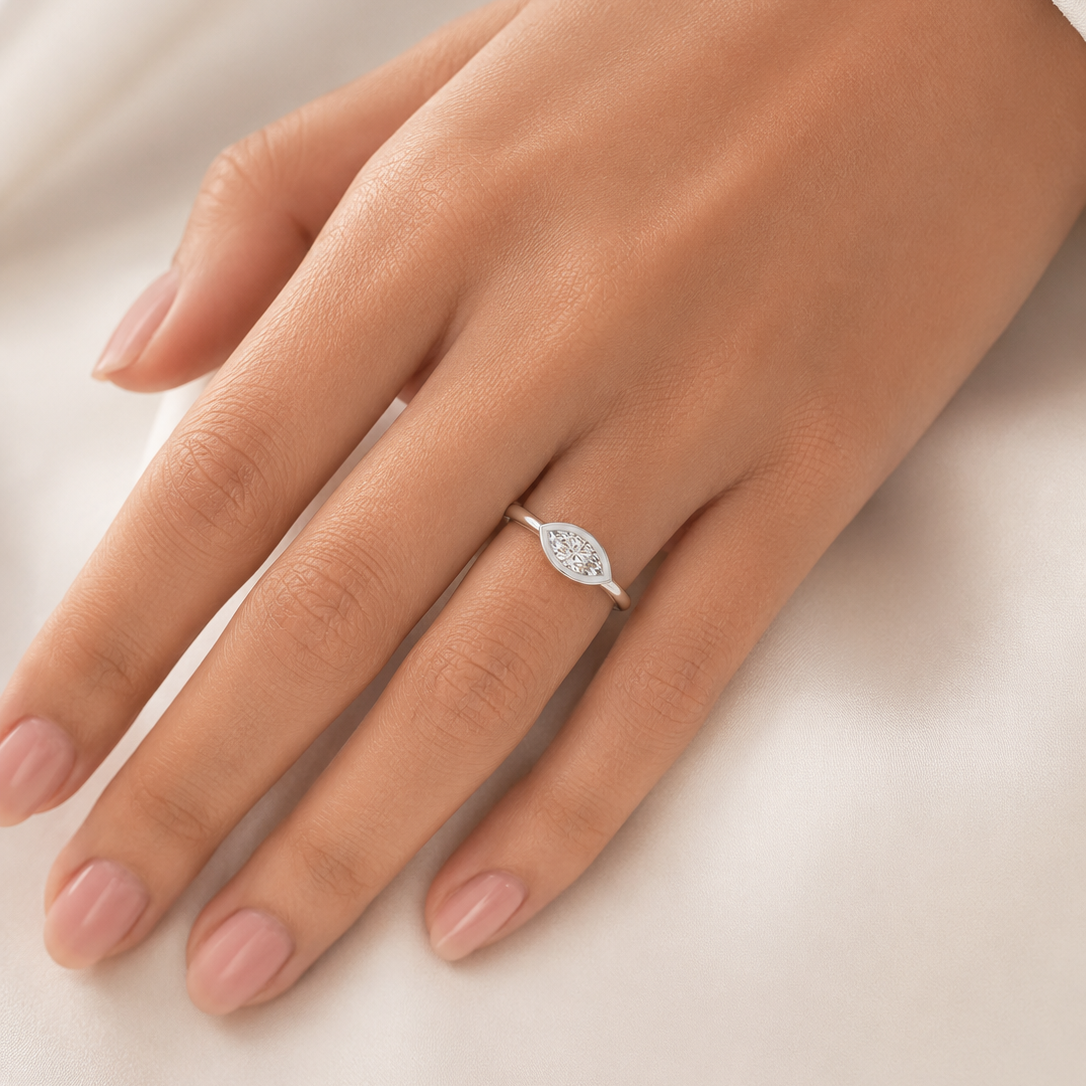 Hand wearing a diamond ring on a white background