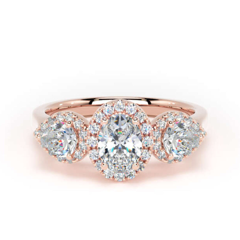 A rose gold three-stone ring featuring a central oval-cut diamond surrounded by small round diamonds, flanked by two marquise-cut diamonds, also accented with small round diamonds, set against a plain white background.