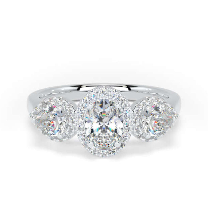 A silver three-stone diamond ring with a central round brilliant-cut diamond flanked by two marquise-cut diamonds in round halo settings, shown on a plain white background.