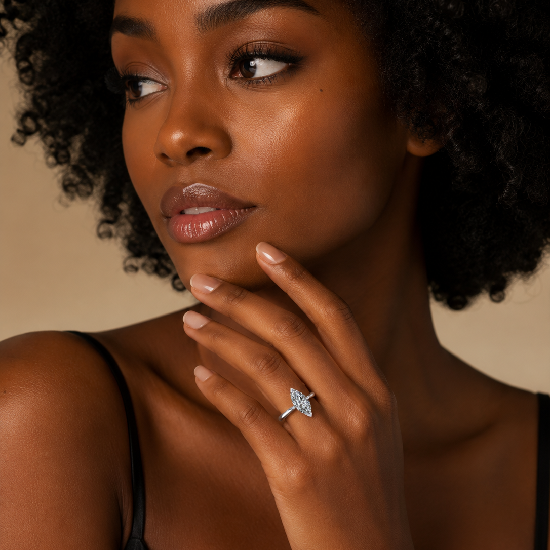 Woman wearing a diamond ring on a beige background