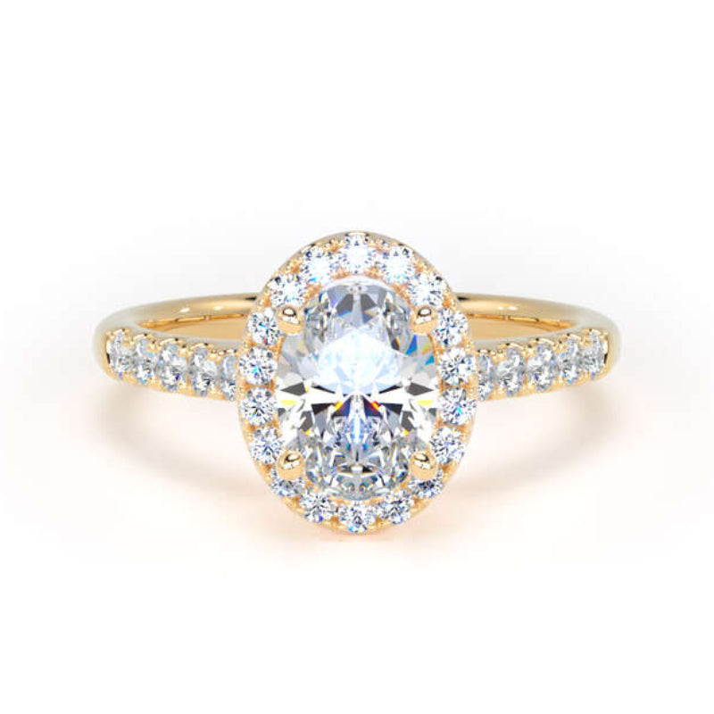 A yellow gold halo ring featuring a large oval-cut center stone surrounded by a double halo of smaller round stones, with a pavé band on a clean white background.